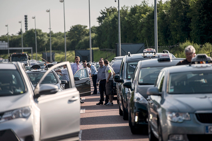 Taxis drivers block highway outside Paris, near Roissy on June 11, 2014, as they take part in a demonstration to protest against the growing number of minicabs, known in France as âVoitures de Tourisme avec Chauffeursâ (VTC). (AFP Photo / Fred Dufour)