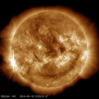 The second X-class flare of June 10, 2014, appears as a bright flash on the left side of this image from NASAâs Solar Dynamics Observatory. This image shows light in the 193-angstrom wavelength, which is typically colorized in yellow. It was captured at 8:55 a.m EDT, just after the flare peaked. (Image Credit: NASA / SDO)