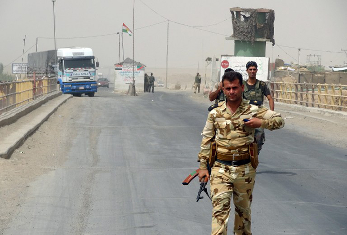 Kurdish Peshmerga forces deploy their troops on the outskirts of the multi-ethnic Iraqi city of Kirkuk, only 1 kilometre away from areas controlled by Sunni Muslim Jihadists from the Islamic State of Iraq and the Levant (ISIL) on the main road between Kirkuk, Mosul and Baiji in northern Iraq on June 12, 2014. (AFP Photo / Marwan Ibrahim)