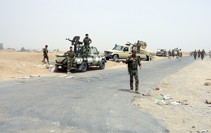 Kurdish Iraqi Peshmerga forces deploy their troops and armoured vehicles on the outskirts of the multi-ethnic city of Kirkuk, only 1 kilometre away from areas controlled by Sunni Muslim Jihadists from the Islamic State of Iraq and the Levant (ISIL) in northern Iraq on June 12, 2014. (AFP Photo / Marwan Ibrahim)