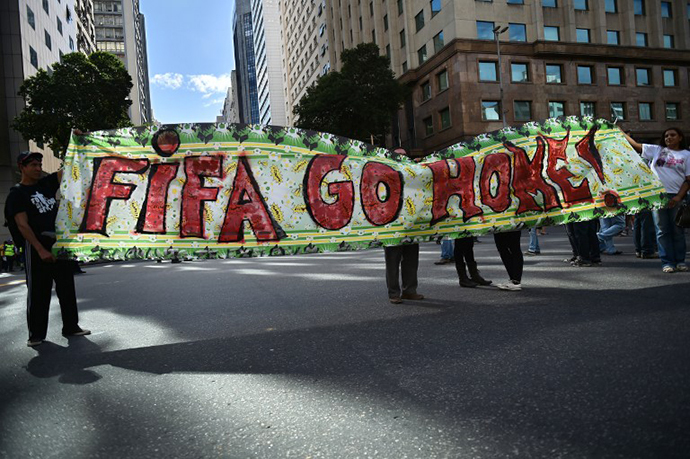 Demonstrators take part in an anti-World Cup protest in Rio de Janeiro on June 12, 2014. (AFP Photo / Yasuyoshi Chiba)