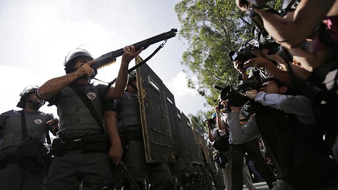 Members of the media film riot policemen during a protest against the 2014 World Cup in Sao Paulo June 12, 2014. (Reuters / Lunae Parracho)