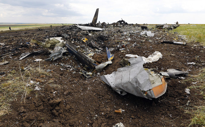 Self-defense forces gather ammunition at the site of the crash of the Il-76 Ukrainian army transport plane in Luhansk, June 14, 2014. (Reuters/Shamil Zhumatov)