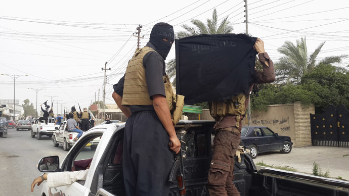 Fighters of the Islamic State of Iraq and the Levant (ISIL) celebrate on vehicles taken from Iraqi security forces, at a street in city of Mosul, June 12, 2014. (Reuters)