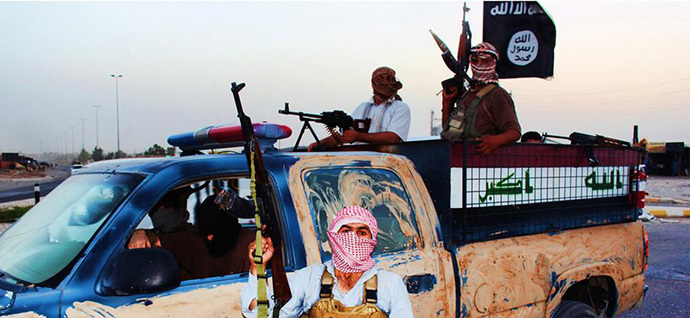 Militants of the Islamic State in Iraq and the Levant (ISIS) riding in a captured vehicle left behind by Iraqi security forces at an unknown location in the Salaheddin province on June 14, 2014. (AFP Photo / HO / Welayat Salahuddin)