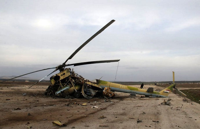 A picture taken on March 1, 2014 shows the wreckage of a Syrian army helicopter after al-Qaeda-linked group Islamic State of Iraq and the Levant (ISIL)'s fighters allegedly destroyed it. (AFP Photo / Mohammed Al-Khatieb)
