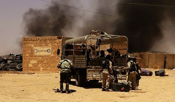 An image made available by the jihadist Twitter account Al-Baraka news on June 9, 2014 allegedly shows Islamic State of Iraq and the Levant (ISIL) militants taking position at a Iraqi border post on the Syrian-Iraqi border between the Iraqi Nineveh province and the Syrian town of Al-Hasakah. (AFP Photo)