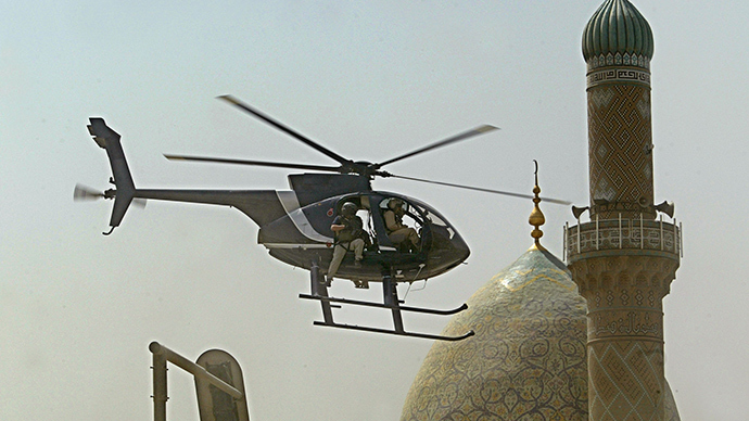 ARCHIVE PHOTO: A helicopter of Blackwater security firm flies low above the scene where a roadside bomb exploded near the Iranian embassy in central Baghdad, 05 July 2005 (AFP Photo / Yuri Cortez)
