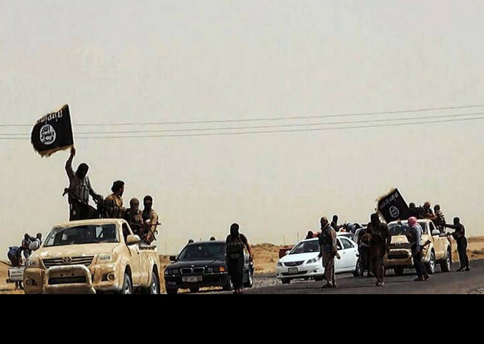 An image uploaded on June 14, 2014 on the jihadist website Welayat Salahuddin allegedly shows militants of the Islamic State of Iraq and the Levant (ISIL) driving on a street at unknown location in the Salaheddin province. (AFP Photo)