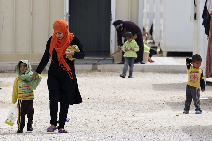 A Syrian refugee woman walks with her son inside the Mrajeeb Al Fhood refugee camp, east of the city of Zarqa April 13, 2014. (Reuters)