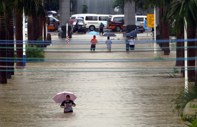 Residents wade through flood water along a street amid heavy rainfalls in Zengcheng, Guangdong province May 23, 2014. (Reuters)