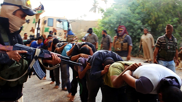 An image uploaded on June 14, 2014 on the jihadist website Welayat Salahuddin allegedly shows militants of the Islamic State of Iraq and the Levant (ISIL) capturing dozens of Iraqi security forces members prior to transporting them to an unknown location in the Salaheddin province ahead of executing them (AFP Photo)