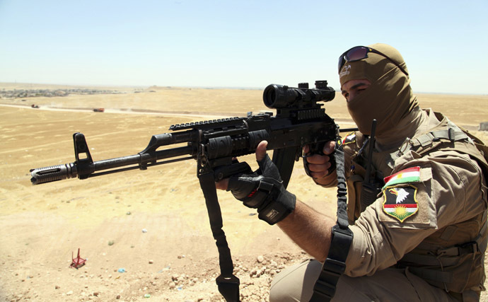 A member of Kurdish security forces aims his rifle during an intensive security deployment and a patrol looking for militants of the Islamic State of Iraq and the Levant (ISIL), on the outskirts of Mosul, June 22, 2014. (Reuters/Azad Lashkari)