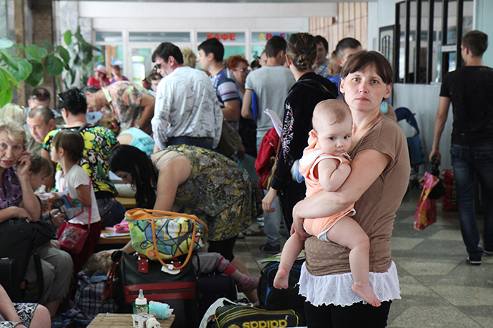 Refugees from southeastern Ukraine unpack bags with aid prepared for them at the transit refugee camp at Artek Center in Simferopol (Reuters / Andrey Iglov)