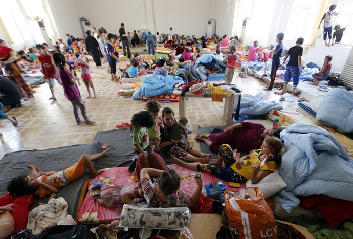 Iraqi Christian families fleeing the violence in the village of Qaraqush and Bartala, about 30 kms east of the northern province of Nineveh, are pictured at a community center in the Kurdish city of Arbil in Iraq's autonomous Kurdistan region, on June 27, 2014. (AFP Photo / Karim Sahib)