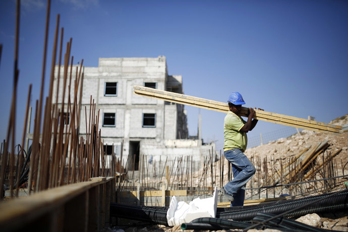 A labourer works on a construction site in Pisgat Zeev, an urban settlement in an area Israel annexed to Jerusalem after capturing it in the 1967 Middle East war August 12, 2013. (Reuters/Amir Cohen)