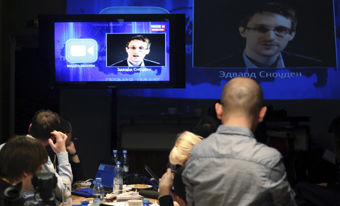 Journalists listen to a speech and a question posed by former U.S. spy agency NSA contractor Edward Snowden, at a media centre during Russian President Vladimir Putin's live broadcast nationwide phone-in, in Moscow April 17, 2014. (Reuters)