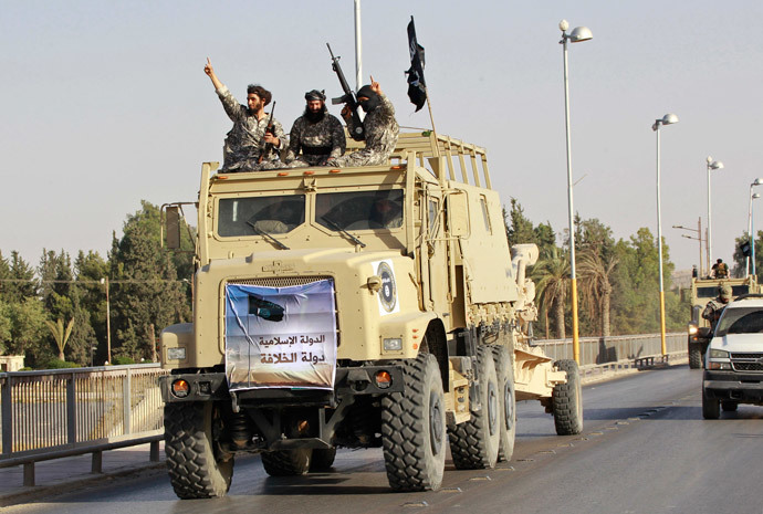 Militant Islamist fighters take part in a military parade along the streets of Syria's northern Raqqa province June 30, 2014. (Reuters / Stringer)