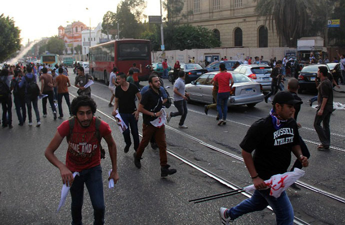 Egyptian demonstrators clash with police following a protest against the demonstration law, near the Presidential Palace in Cairo on June 21, 2014. (AFP Photo / Ahmed Tarana)
