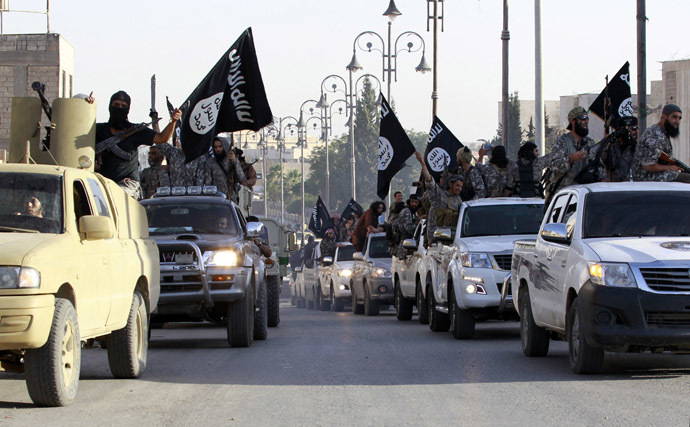 Militant Islamist fighters parade on military vehicles along the streets of northern Raqqa province June 30, 2014. (Reuters)