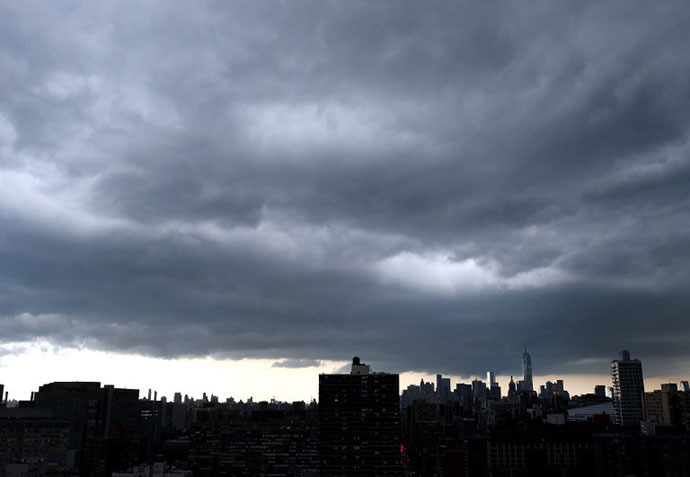 Dark clouds form over lower Manhattan as a major storm comes in over the city July 2, 2014. (AFP Photo / Timothy A. Clary)