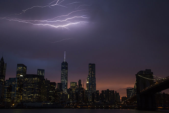 Lightning strikes above the Manhattan skyline during sunset after a summer storm in New York July 2, 2014. (Reuters / Lucas Jackson)