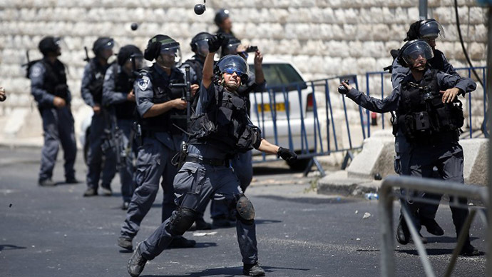 Israeli police throw stun grenades toward Palestinians during clashes after the Friday prayer outside of the Old City in East Jerusalem on July 4, 2014. (AFP Photo / Thomas Coex)