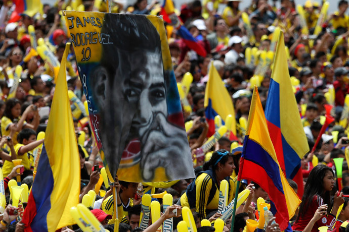 A Colombian fan holds a banner of James Rodriguez while waiting with other fans for the arrival of Colombia's national soccer team at Bolivar park in Bogota July 6, 2014.(Reuters / John Vizcaino)