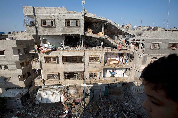A picture taken in Gaza City on July 10, 2014 shows a damaged building after it was hit by an Israeli air strike. The Israeli air force overnight hit more than 300 Hamas targets in the Gaza Strip in response to rocket fire from the besieged Palestinian territory, an army spokesman said (AFP Photo / Mohammed Abed)
