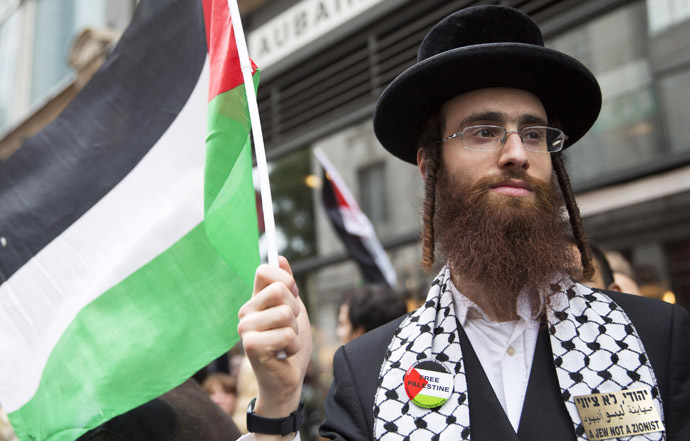 An ultra-Orthodox Jew holds a Palestinian flag during a protest against Israel's air strikes in Gaza in London July 11, 2014. (Reuters/Neil Hall)