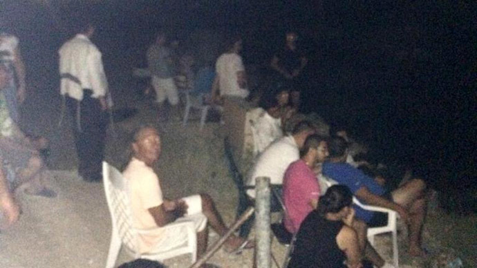 Twitter uproar over pic of 'applauding' Israelis watching night attacks on Gaza