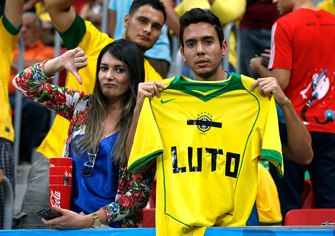 Fans hold up a Brazil jersey reading, "Mourn" during the 2014 World Cup third-place playoff between Brazil and the Netherlands at the Brasilia national stadium in Brasilia July 12, 2014. (Reuters / Jorge Silva)