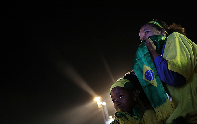 A Brazilian fan and her mother react as they watch a broadcast of the 2014 World Cup third-place playoff between Brazil and the Netherlands on Copacabana beach in Rio De Janeiro, July 12, 2014. (Reuters / Nacho Doce)