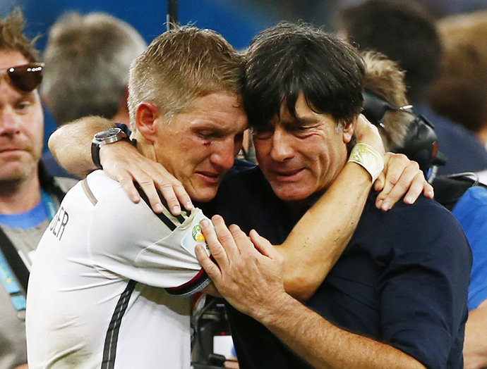 Germany's Bastian Schweinsteiger (L) embraces coach Joachim Loew as they celebrate their win against Argentina after their 2014 World Cup final at the Maracana stadium in Rio de Janeiro July 13, 2014. (Reuters / Michael Dalder)