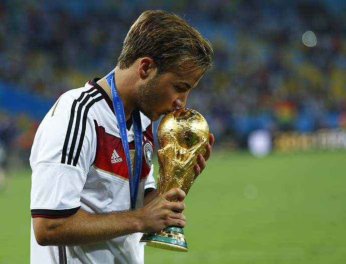 Germany's Mario Goetze kisses the World Cup trophy after the 2014 World Cup final against Argentina at the Maracana stadium in Rio de Janeiro July 13, 2014. (Reuters / Eddie Keogh)