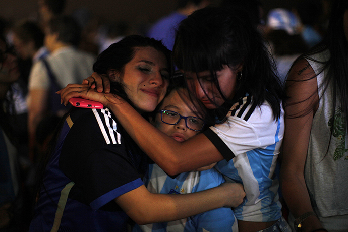 Argentina supporters react after Argentina lost to Germany in their 2014 World Cup final soccer match in Brazil, during a screening at a beach in Rincon de la Victoria, near Malaga, late July 13, 2014. (Reuters / Jon Nazca)