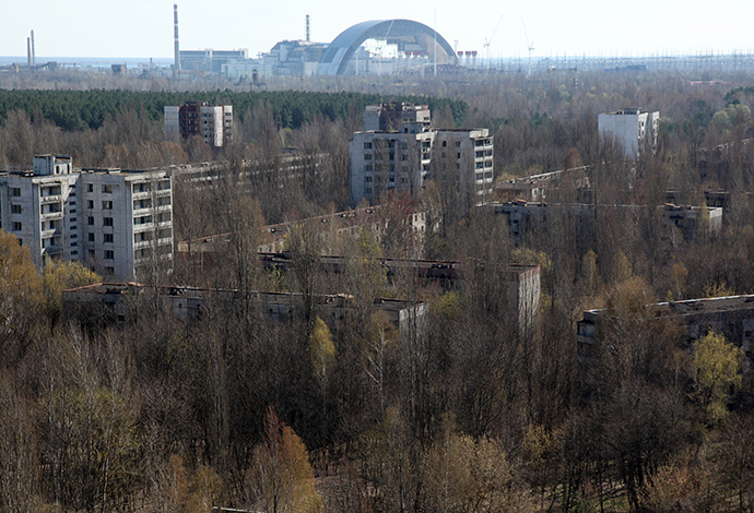 The first half of the Chernobyl New Safe Confinement, or NSC, an arch that which will cover the reactor building, is seen after it was pushed to its site at the Chernobyl Nuclear Power plant on April 3, 2014 (AFP Photo / Anatoly Stepanov)