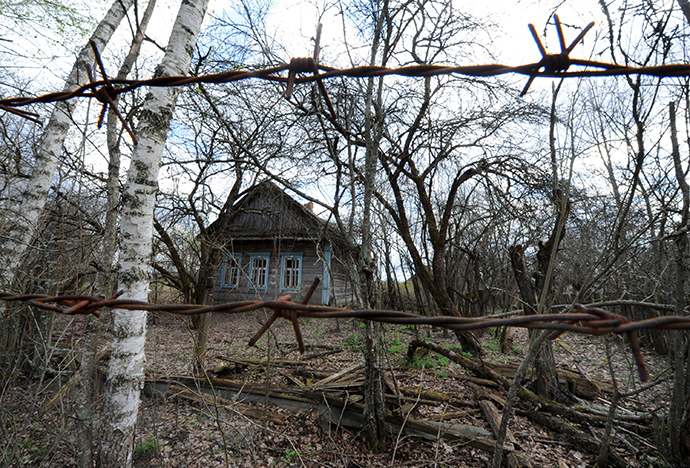 A picture taken through a barbed wire shows the abandoned village of Vezhishche in the 30 km exclusion zone around the Chernobyl nuclear reactor, some 380 km southeast of the Belarus capital Minsk (AFP Photo / Viktor Drachev)