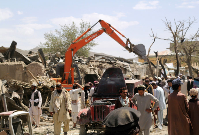 Villagers gather at the site of a car bomb attack in Urgon district eastern province of Paktika July 15, 2014. (Reuters / Stringer)