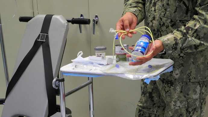 A US naval medic holds liquid food supplement force fed to hunger strikers at the US Naval Base in Guantanamo Bay, Cuba (AFP Photo / Chantal Valery)