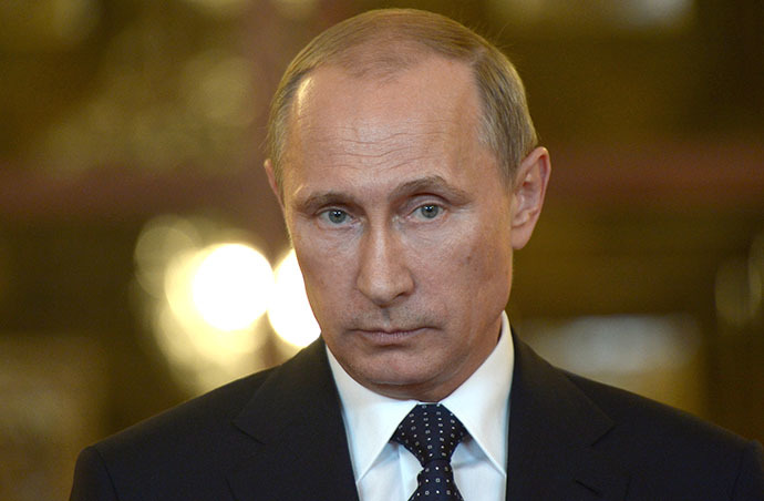 Russia's President Vladimir Putin looks on while speaking with journalists in Itamaraty Palace in Brazilia, early on July 17, 2014. (AFP Photo / Alexei Nikolsky)