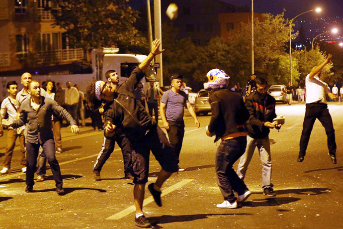 Demonstrators throw stones at the Israeli Embassy in Ankara, as they protest against Israel's military action in Gaza, on July 18, 2014. (AFP Photo / Adem Altan)