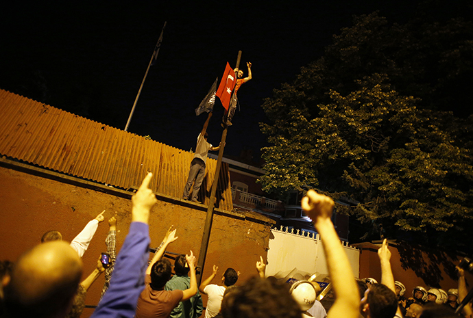 Demonstrators climb a wall and pole at the Israeli Embassy in Ankara as others shout slogans, during a protest against Israel's military action in Gaza, July 18, 2014. (Reuters / Umit Bektas)