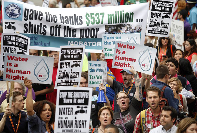 Demonstrators protest against the Detroit Water and Sewer Department July 18, 2014 in Detroit, Michigan. The Detroit Water and Sewer Department have disconnected water to thousands of Detroit residents who are delinquent with their bills. (AFP Photo / Getty Images / Joshua Lott)