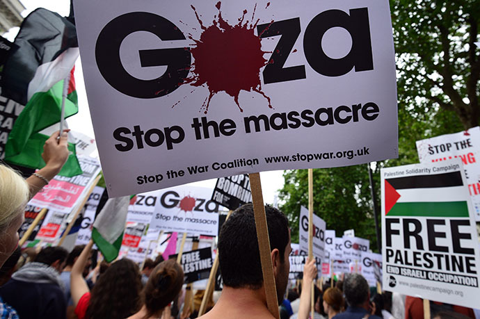 Protesters display placards and banners as they take part in demonstration against Israeli airstrikes in Gaza in central London on July 19, 2014 against Gaza strikes. (AFP Photo / Carl Court)