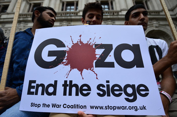 Protesters display a banner as they take part in demonstration against Israeli airstrikes in Gaza in central London on July 19, 2014 against Gaza strikes. (AFP Photo / Carl Court)