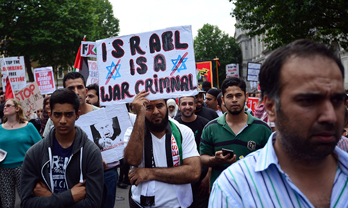 Protesters display placards and banners as they take part in demonstration against Israeli airstrikes in Gaza in central London on July 19, 2014 against Gaza strikes. (AFP Photo / Carl Court)