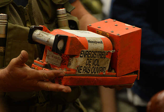 A rescue worker walks across a field carrying a flight data recorder at the crash site of Malaysia Airlines Flight MH17 in Hrabove July 18, 2014 in this still image taken from video (Reuters)