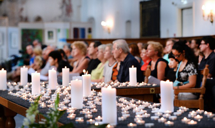 People attend a service in memory of the 298 victims of the downed Malaysia Airlines flight MH17 on July 23, 2014 at the Joriskerk church in Amersfoort. (AFP Photo / Piroschka van de Wouw)