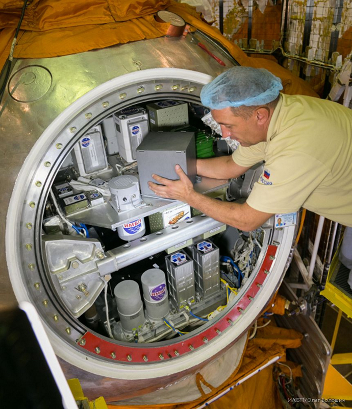 Containers with biological experiment equipment being loaded into the Foton-M satellite. Photo by the Institute for Biomedical Problems (Image from imbp.ru)